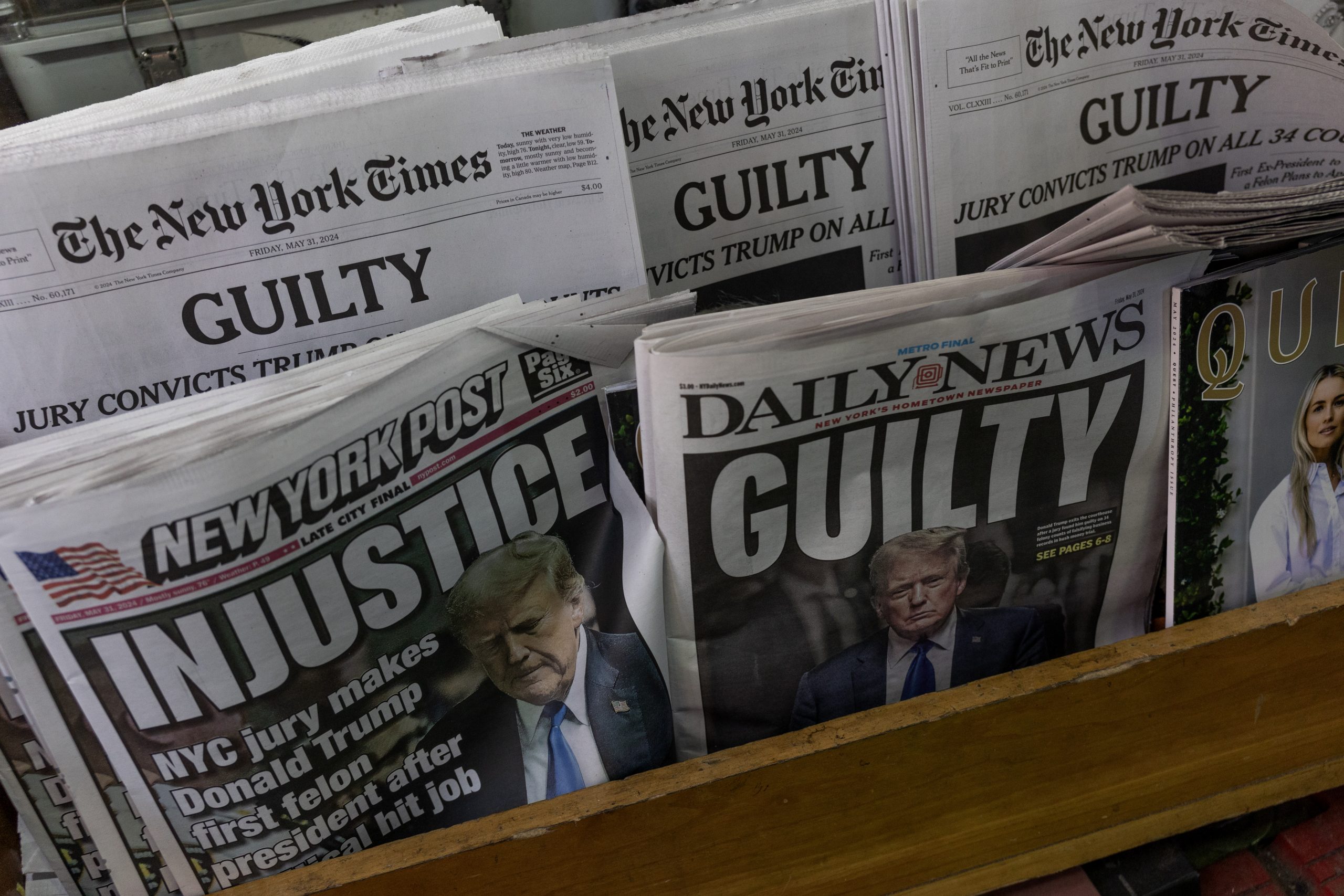 New York newspapers with "guilty" and "injustice" headlines.
