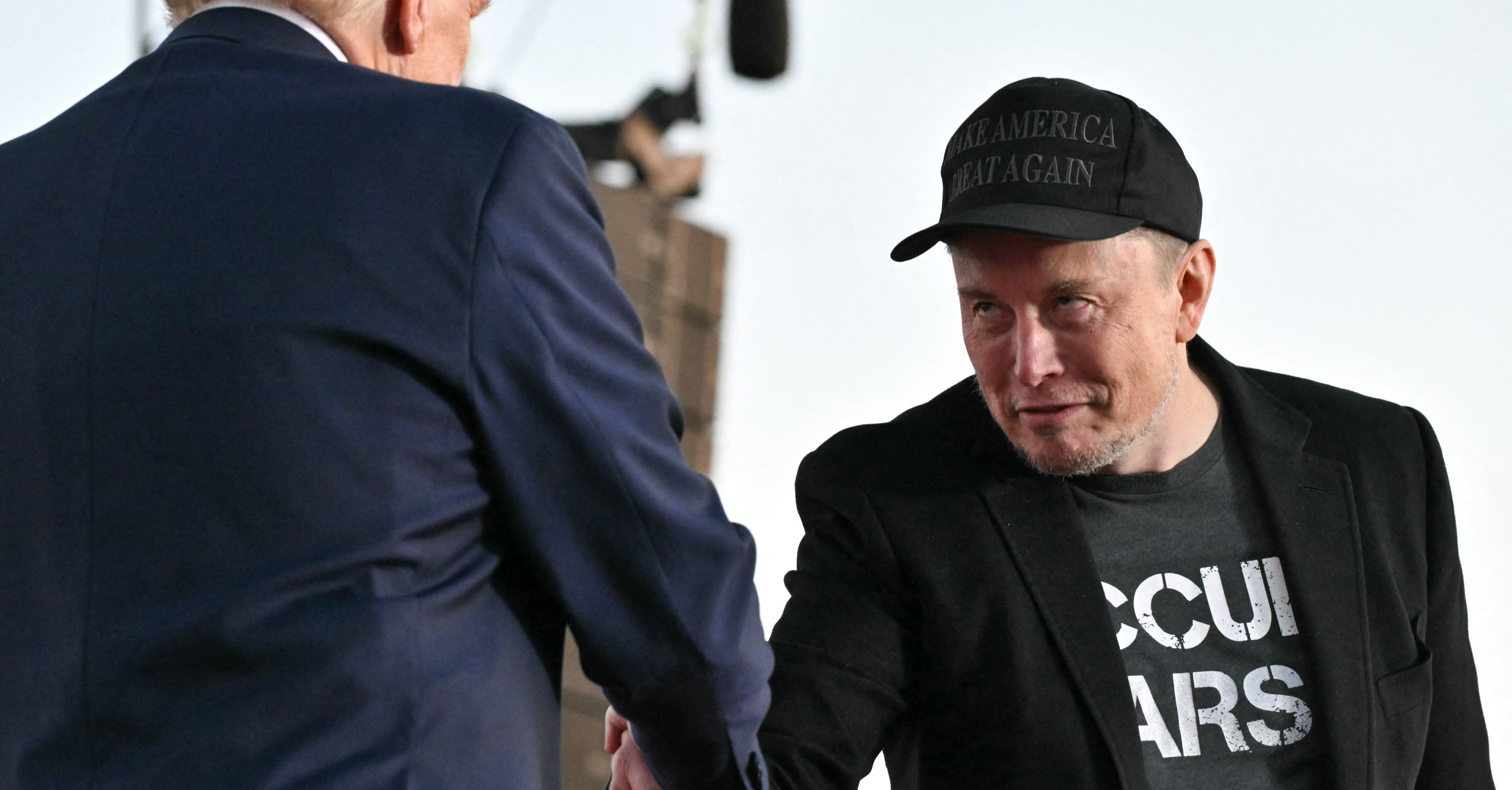 Musk and Trump shaking hands Musk and Trump shaking hands