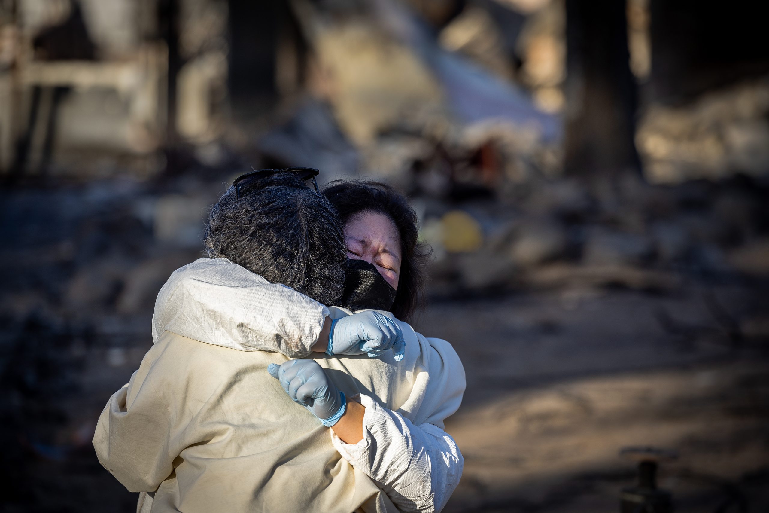 Two wildfire victims hugging each other