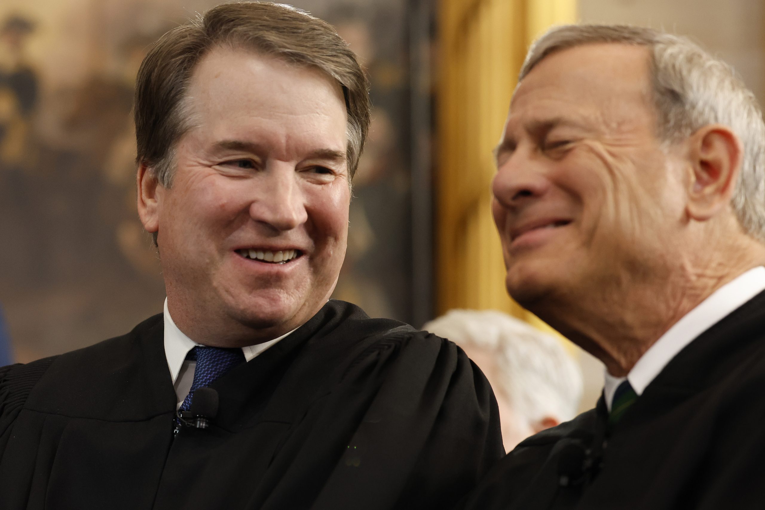 Justice Brett Kavanaugh and Chief Justice John Roberts laughing.