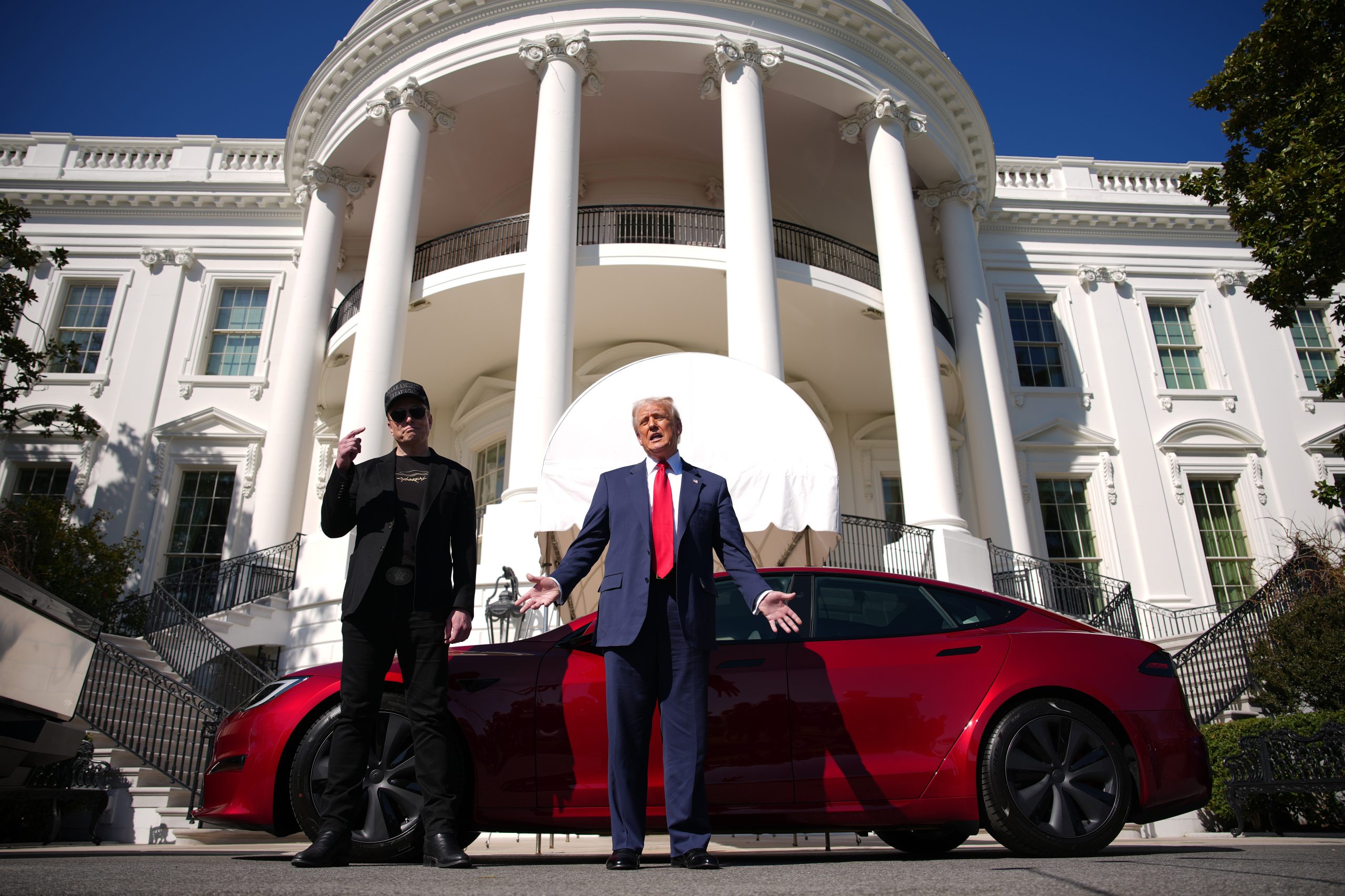 President Donald Trump and Elon Musk deliver remarks next to a Tesla Model S on the South Lawn of the White House.