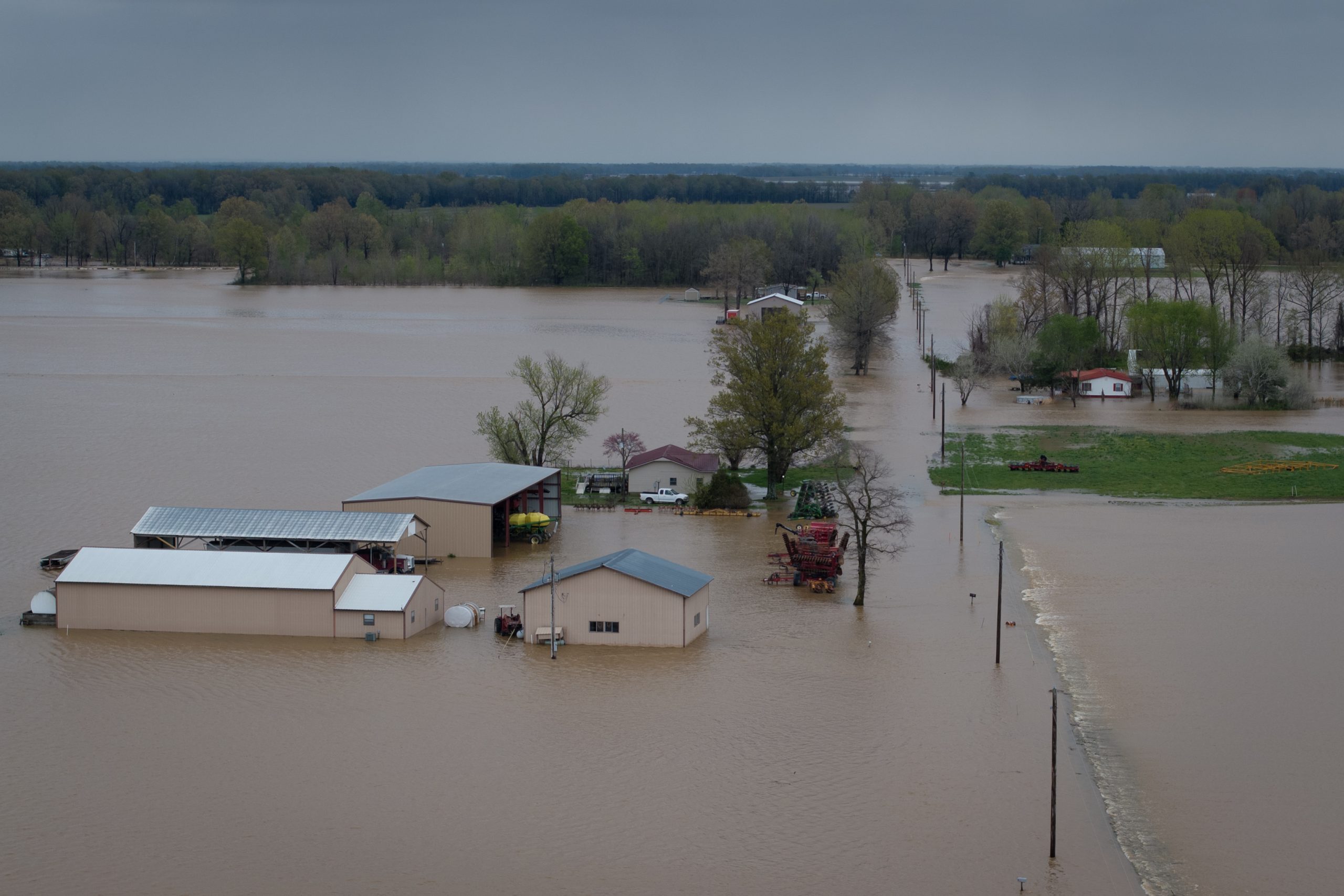 An aerial view of floodwaters covering farm fields