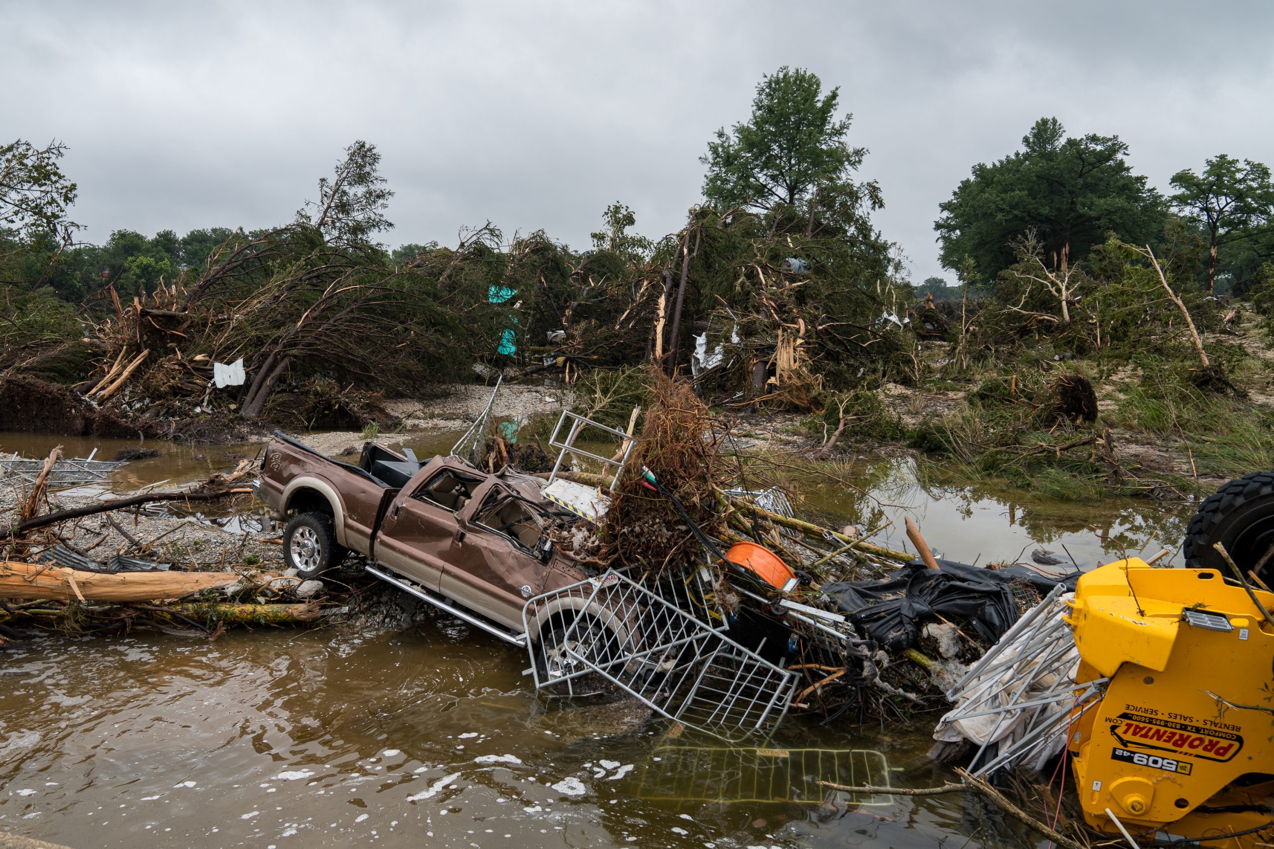 Scattered debris, including vehicles and equipment after severe flooding