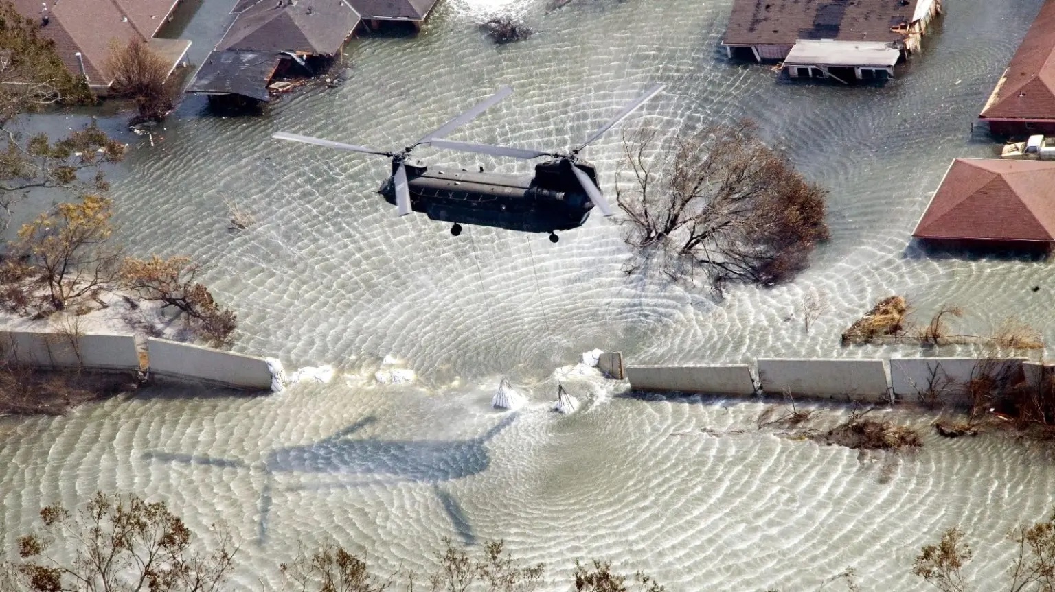 A Chinook helicopter drops sandbags into a breach along the London Avenue canal in New Orleans during Hurricane Katrina
