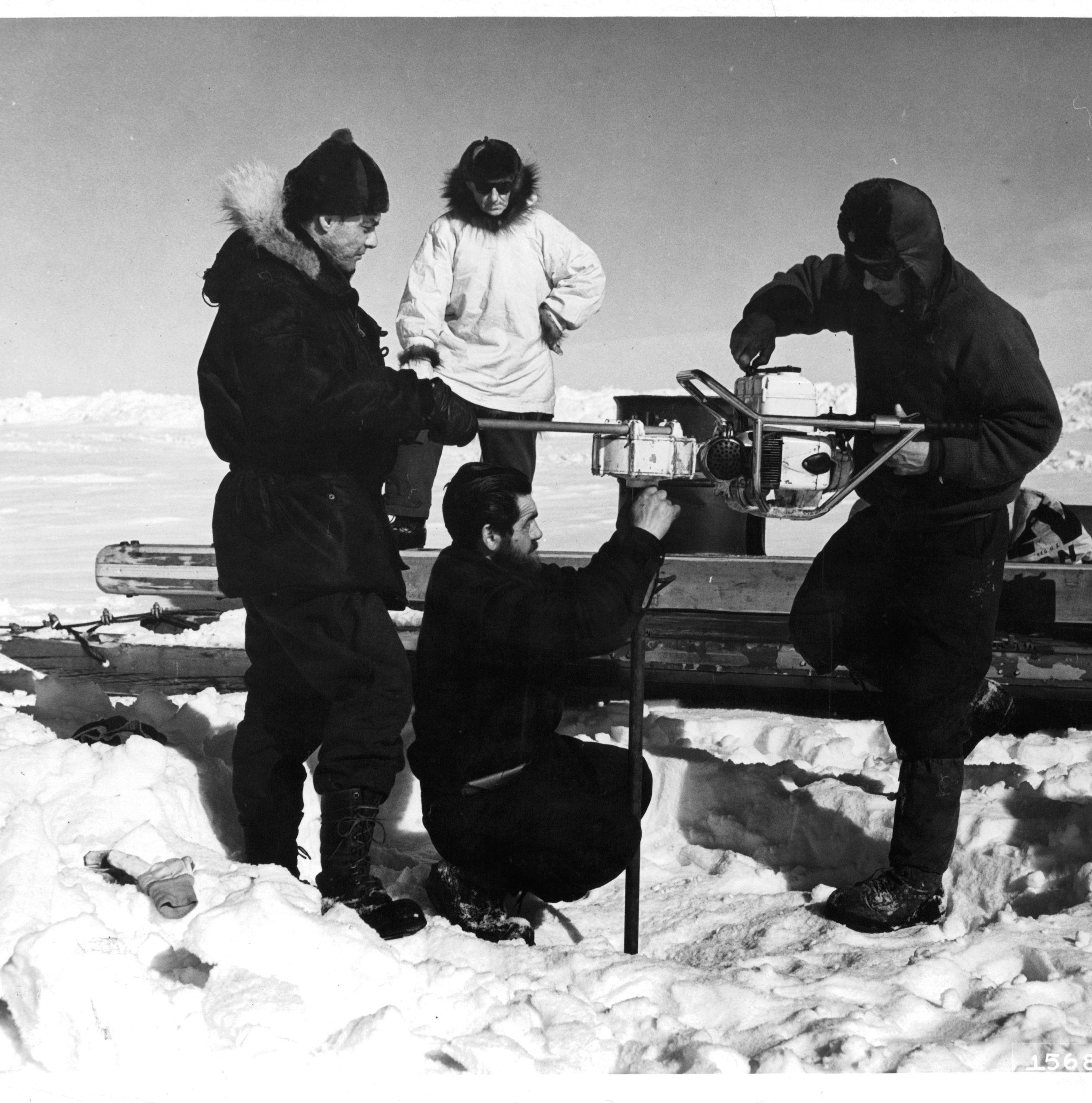 Scientists drilling into an ice sheet. Scientists drilling into an ice sheet.