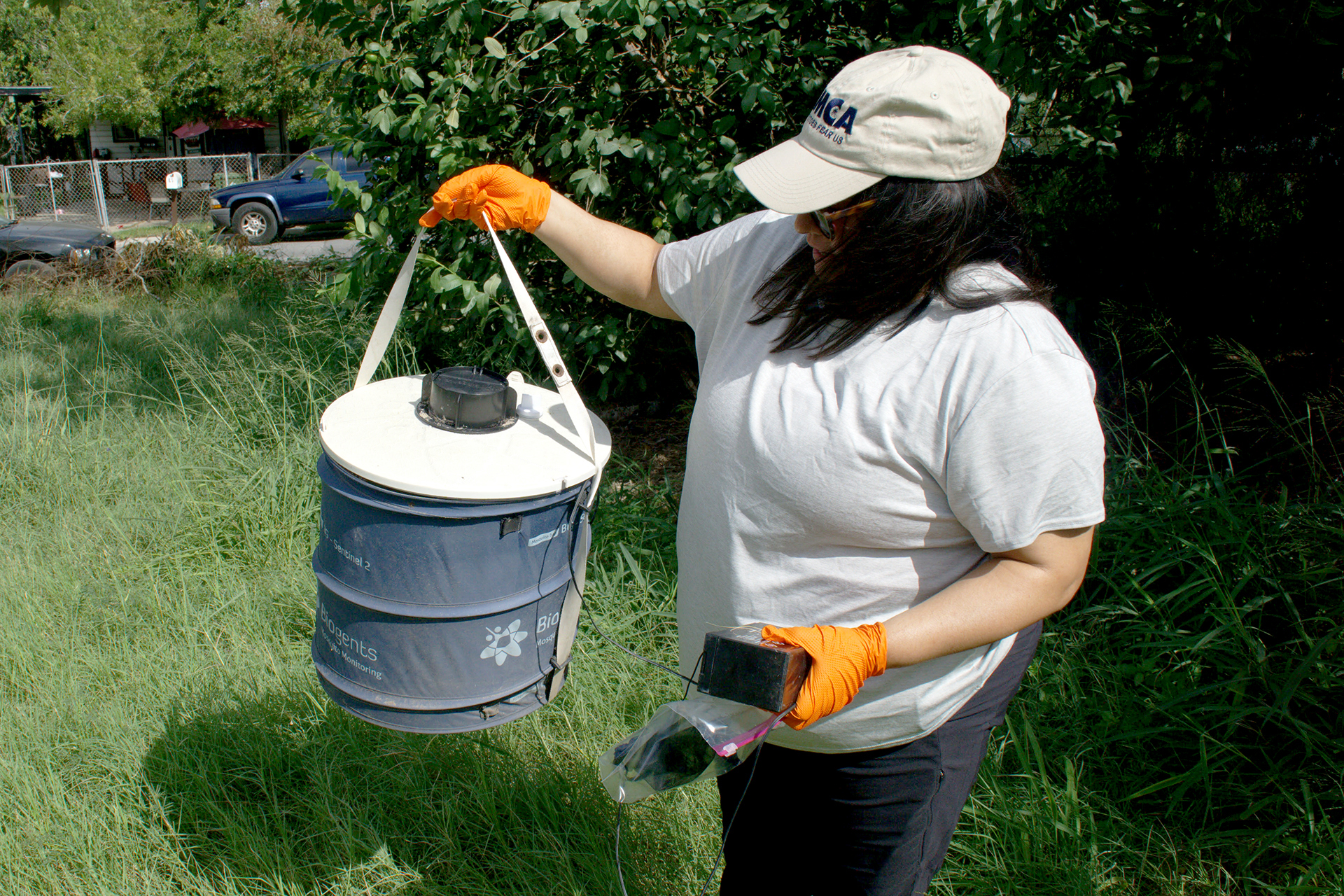 A woman holding a gravid trap