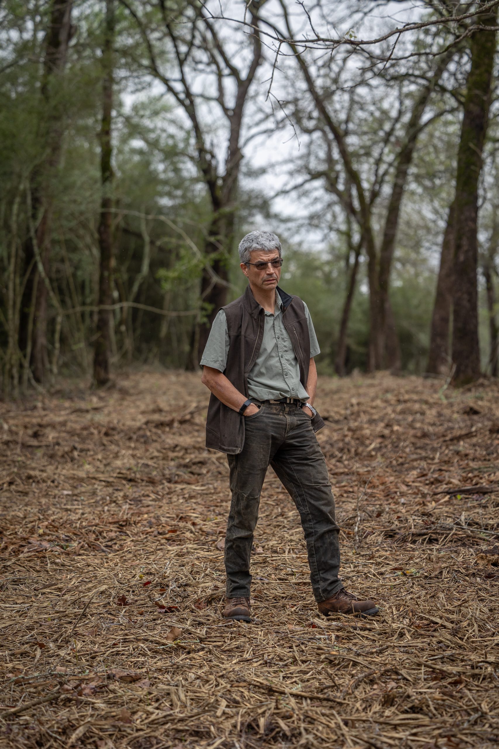 A man stands in a clearing on his 190-acre property A man stands in a clearing on his 190-acre property