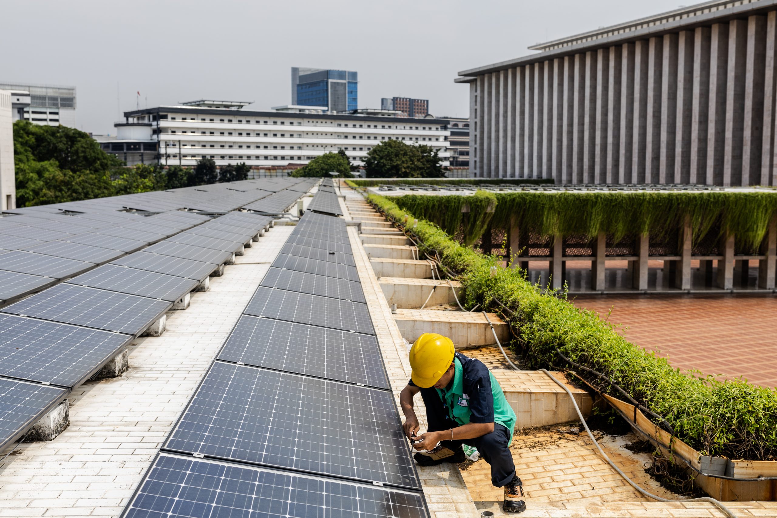 A worker inspecting a solar panel system
